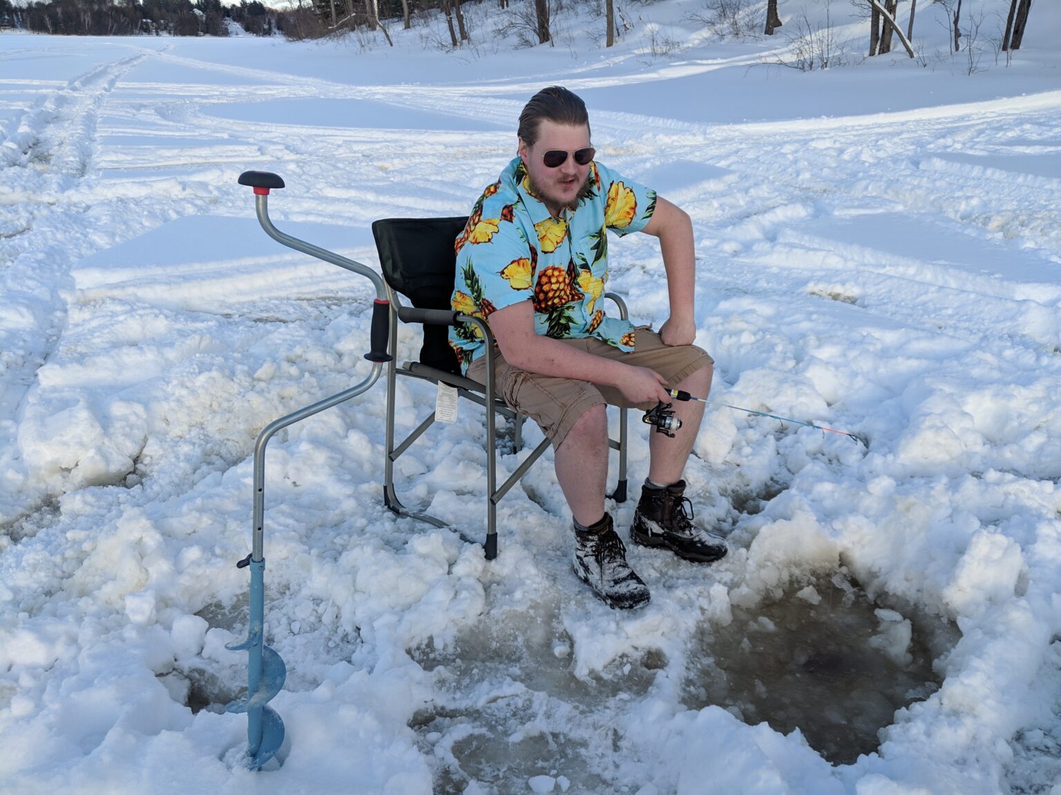Cottage owner ice fishing in winter.